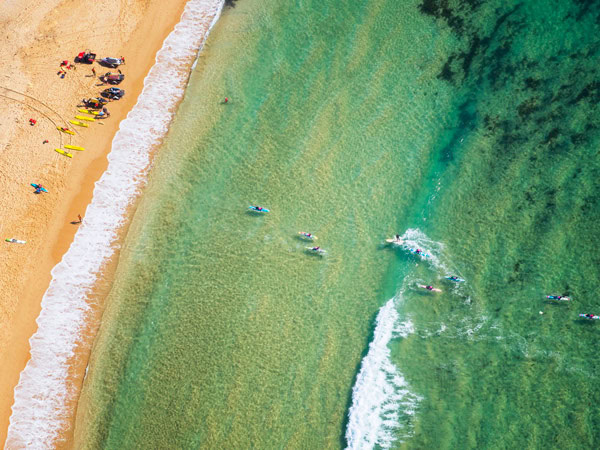 Aerial of paddleboarders at Toowoon Bay, Central Coast.