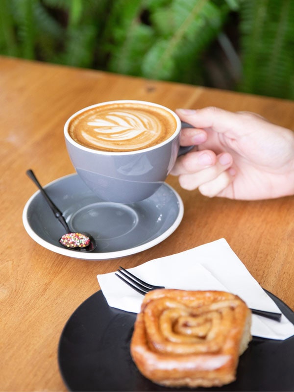 Bella 101 Eumundi serves Padre Coffee alongside a cinnamon scroll