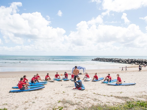 a group of students during a surfing lesson with Merrick’s Noosa Learn to Surf