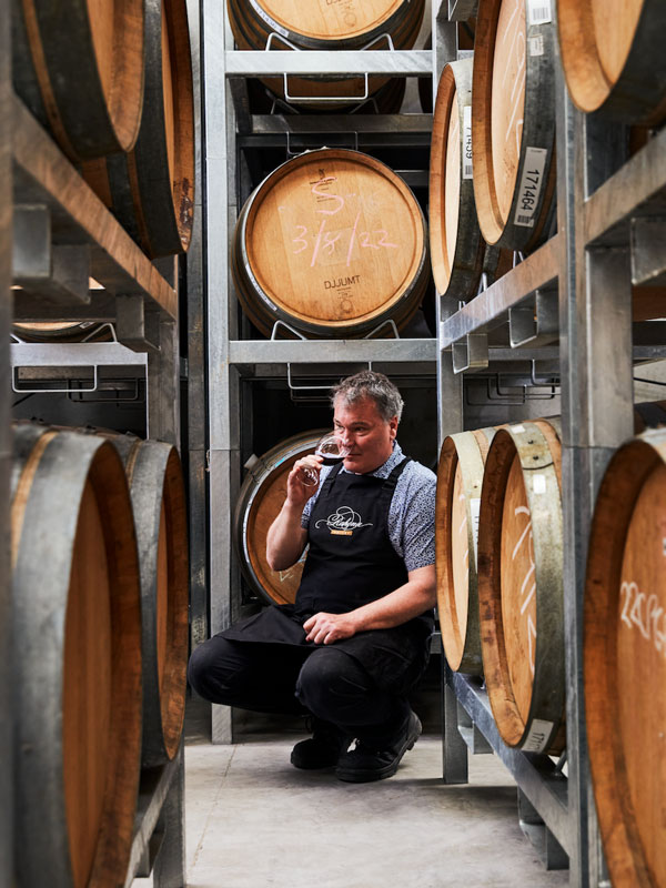 wine tasting in the cellar door filled with barrels at Rahona Valley, Mornington Peninsula