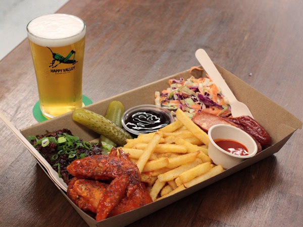 a glass of beer with a share plate at Happy Valley Brewing Company