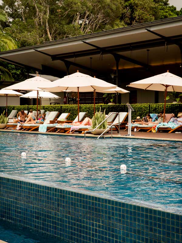 People relaxing by the pool at Crystalbrook Byron, Byron Bay. (Image: Destination NSW)
