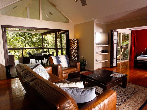 a living room with balcony at Songbirds Rainforest Retreat