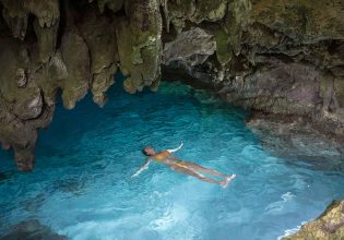 Woman swimming in a grotto on Christmas Island