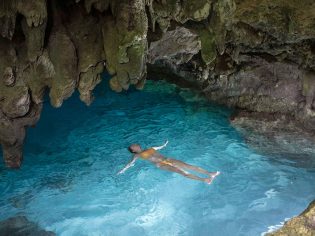 Woman swimming in a grotto on Christmas Island