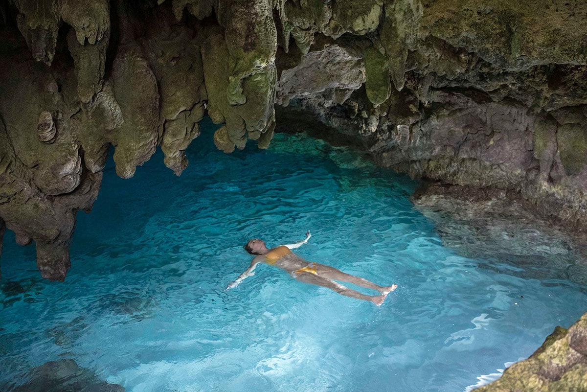 Woman swimming in a grotto on Christmas Island