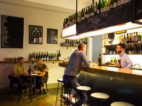 a man sitting by the counter and ordering drinks at Bar Liberty, Melbourne