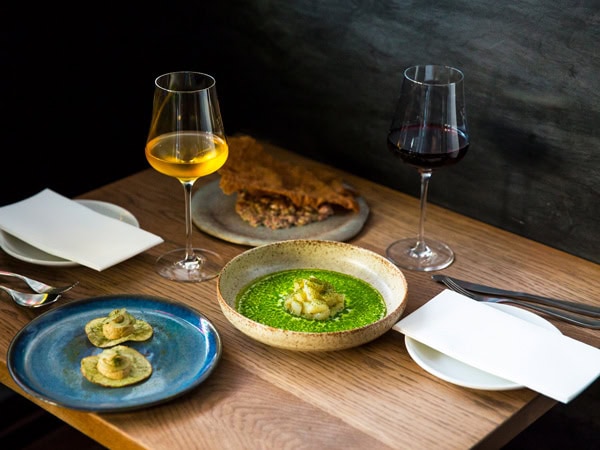 plates of food and drinks on the table at Bar Liberty, Melbourne