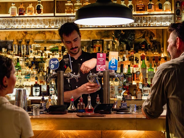 a bartender preparing drinks at the bar, Beneath Driver Lane, Melbourne