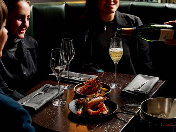 friends enjoying food and drinks at Black Kite Commune, Melbourne