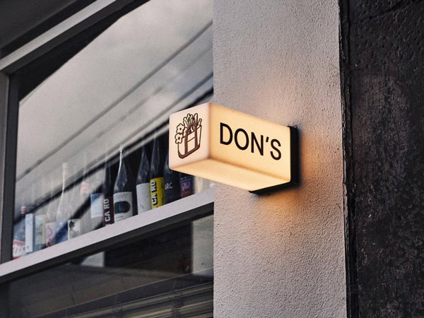 the Don's glowing sign on the side of the wall in Prahran