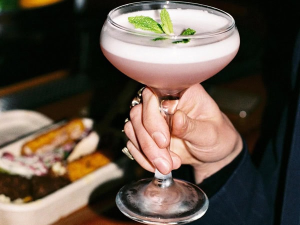 a hand holding a cocktail drink at Monty’s, Fitzroy North