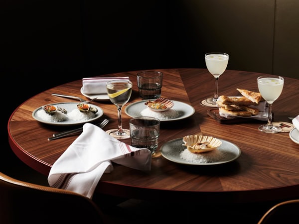 a spread of food and drinks on the table at Tetto Di Carolina, South Yarra