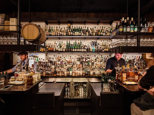 a bartender busy preparing drinks at the counter, Whisky & Alement, Melbourne