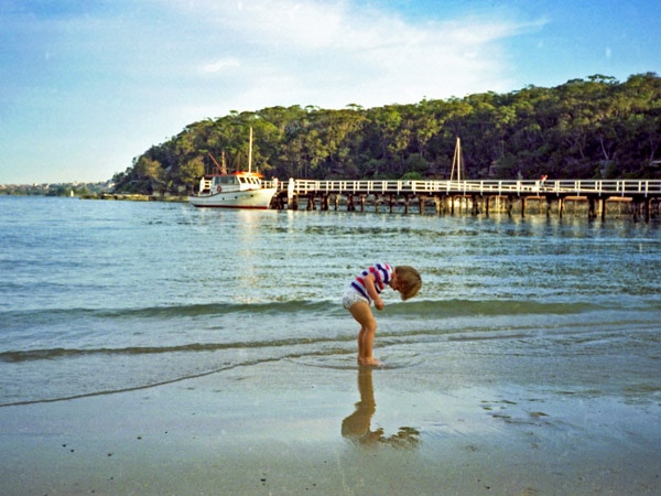 a kid frolicking on the beach at Clifton Gardens, Mosman