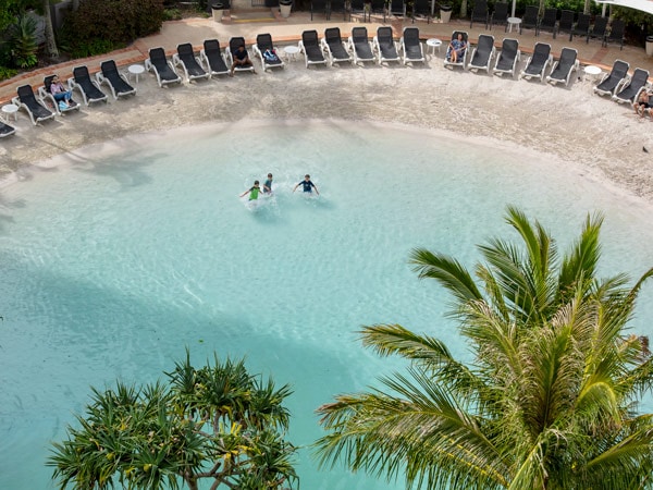 an aerial view of kids playing in the pool at Mantra Crown Towers Surfers Paradise