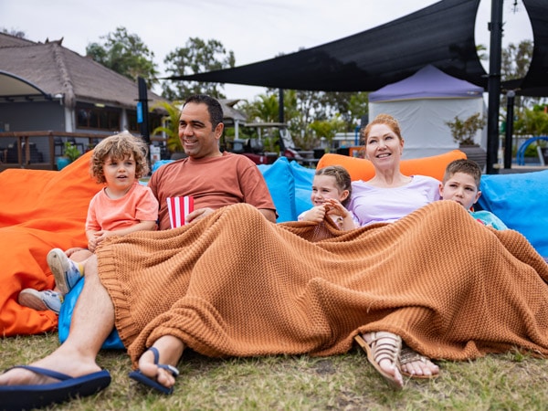 a family sitting together and watching a movie at Treasure Island Holiday Resort