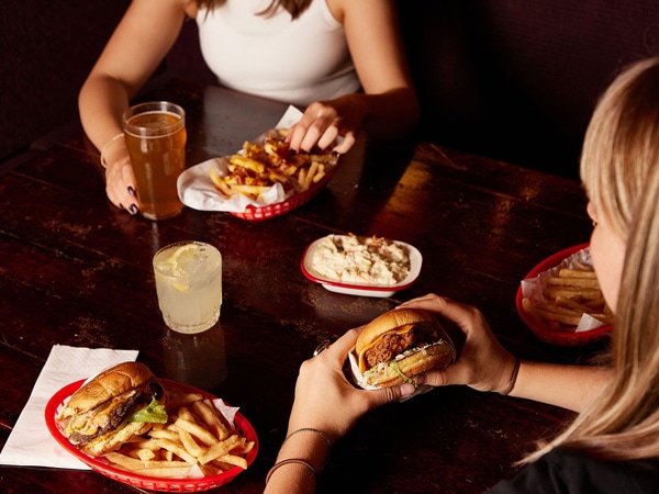 friends eating burgers at The John Curtin Hotel, Carlton