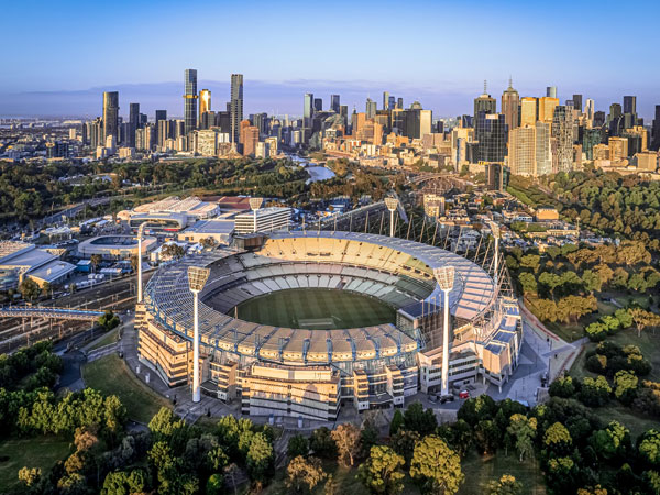 the MCG with city skyline at sunrise