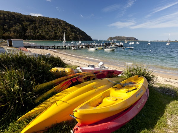 piles of kayak on the beach at Mackerel Beach, Pittwater