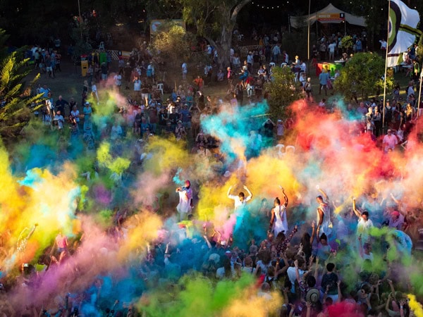 coloured powder being thrown at the crowd during the WOMADelaide festival