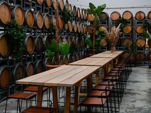 inside seating and wine barrels at H&C Urban Winery