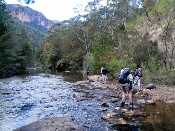 hikers trekking along the river to reach Acacia Flat Campground