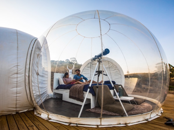 a couple relaxing in their Bubbletent Australia accommodation