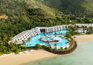 an aerial view of InterContinental Hayman Great Barrier Reef with a pool next to the beach