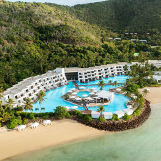 an aerial view of InterContinental Hayman Great Barrier Reef with a pool next to the beach