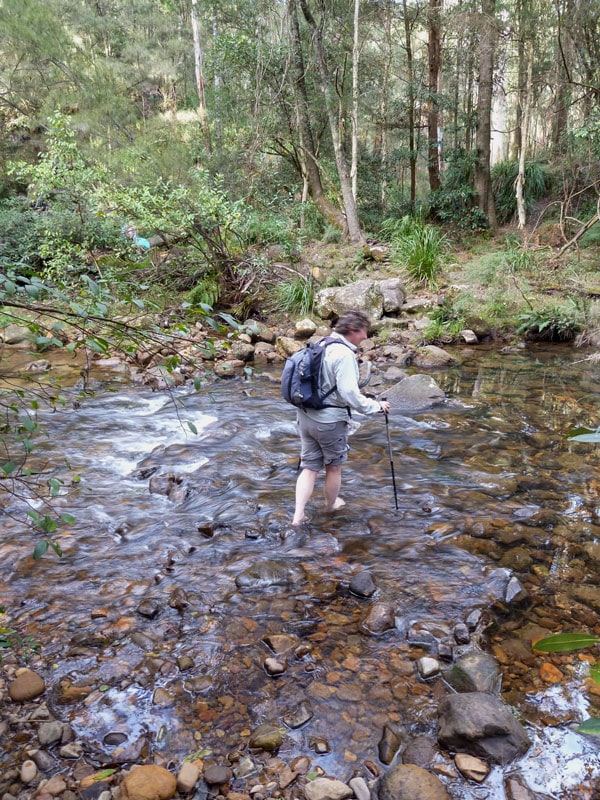 a bushwalker crossing the Kedumba River