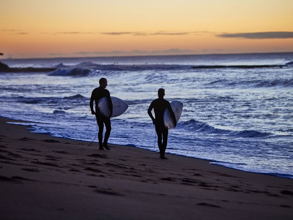 surfers holding their boards at Bells Beach