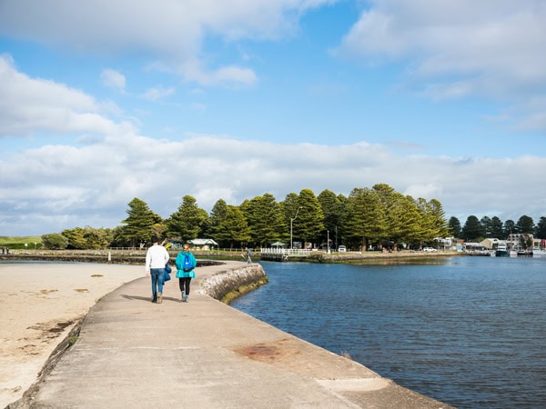 a couple walking on a piece of land at Griffiths Island