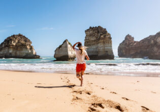 walking barefoot on the sand at at Childers Cove