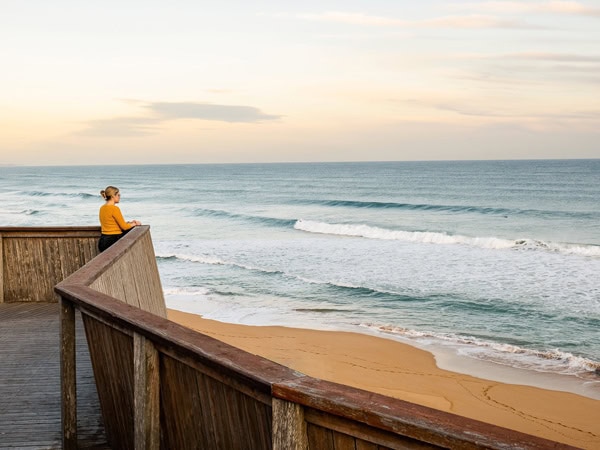 a woman looking out to the sea at Logans Beach