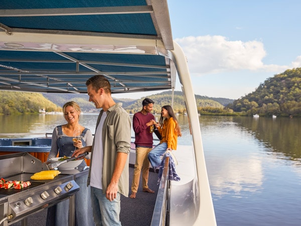 Friends enjoying a barbecue on an Able Hawkesbury River houseboat