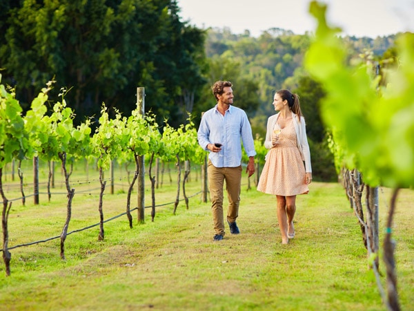 Couple walking through the vineyards near Stanthorpe, Qld