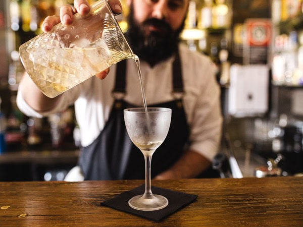 Bartender pours a martini at Bar Toto's in Ettalong