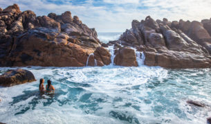 Girls swim in the natural rock pools at Injidup Beach in Yallingup.