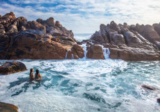 Girls swim in the natural rock pools at Injidup Beach in Yallingup.