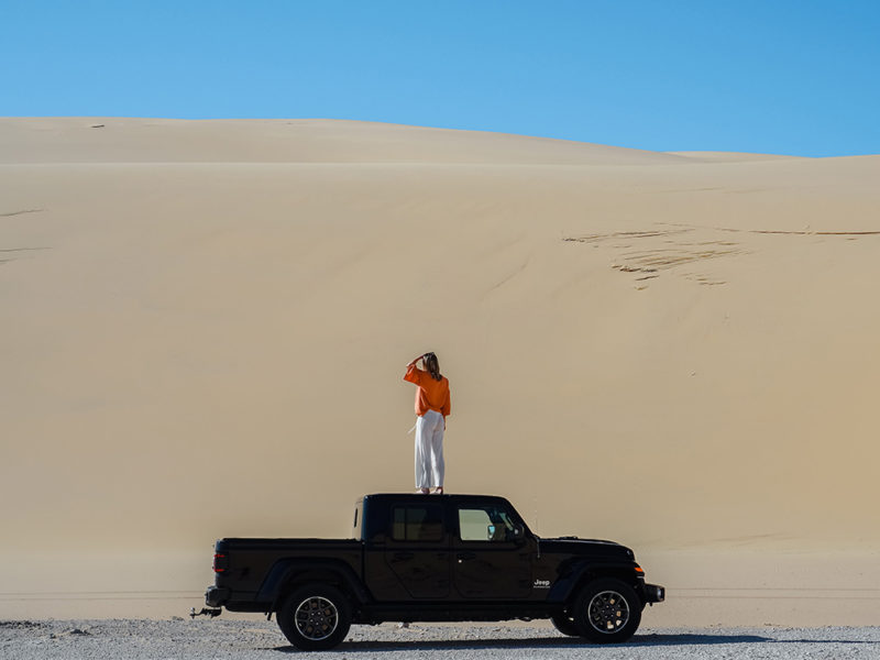Woman standing on Jeep, Stockton Bight Sand Dunes