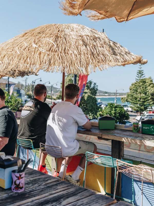 A couple of guys enjoying the views from the rooftop of Mumbo Jumbos in Terrigal