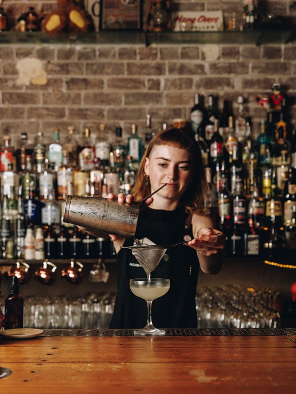 The bartender at Pocket Bar strains a Daiquiri for a customer