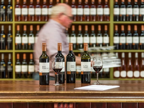 wines on display at the cellar door of Craigmoor Estate Wines with a blurry shot of a man in the background