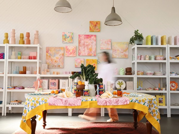 a blurry shot of a person walking inside the boutique shop of Good Day Lifestyle Co. in Mudgee