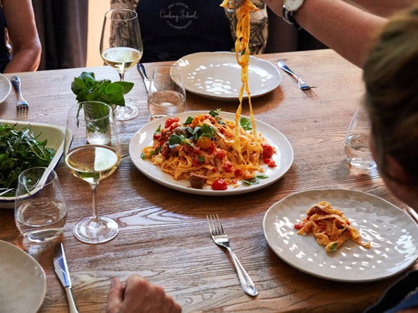 students enjoying a pasta dish at The Little Cooking School, Mudgee