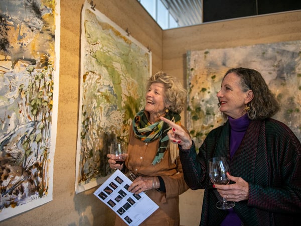 Two women admire the art on show at the gallery at Rosby Wines in Mudgee