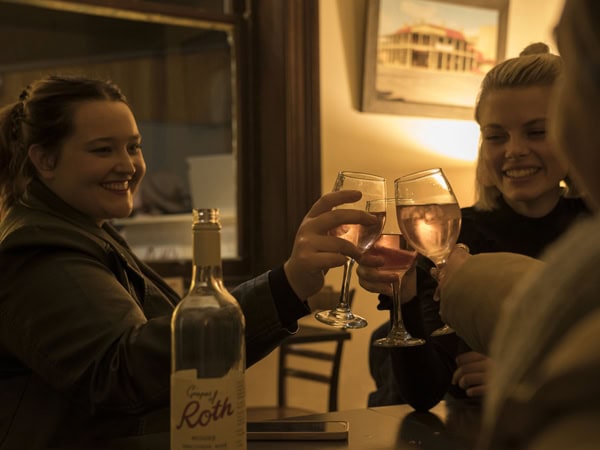friends clinking wine glasses at Roth's Bar, Mudgee