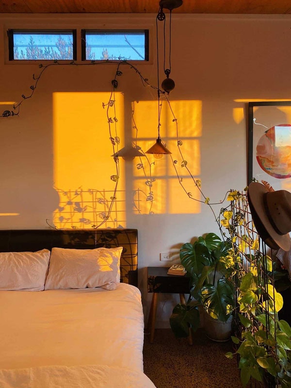 sunlight cast through the walls of the bedroom at Shed By Zin Bed, Mudgee
