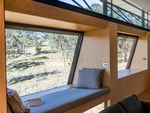 a book on bed overlooking scenic views in Strikes Mudgee